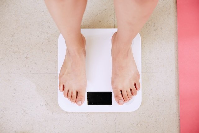 person standing on white digital scales